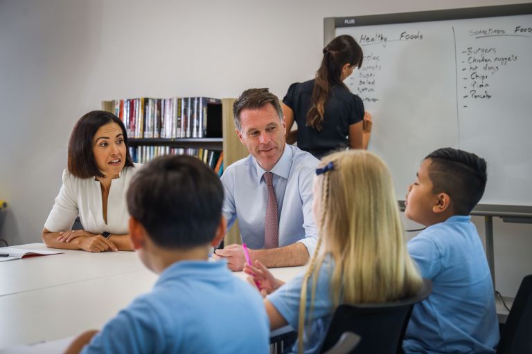 Chris Minns, Premier of New South Wales, in a classroom with students.